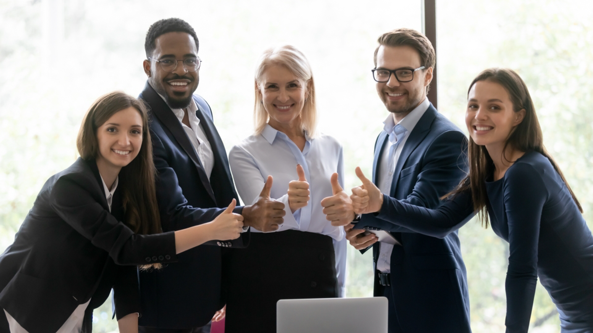 Corporate team smiling in office — representing successful staff augmentation