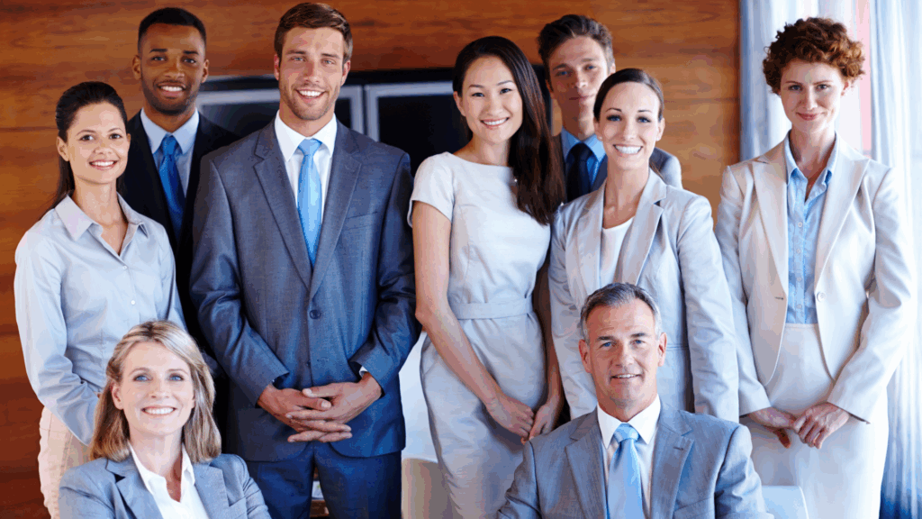 Employees seated together and smiling in an office environment, representing a successful seasonal workforce solution
